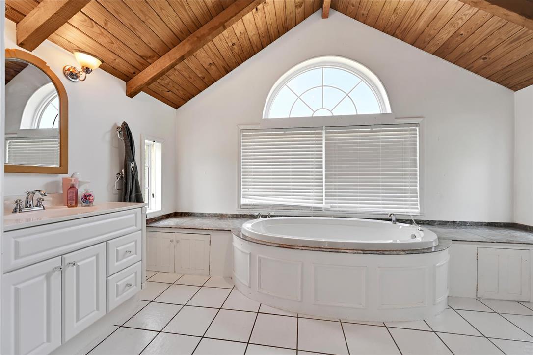101 Conrad Road Fleetwood, PA 19522 - Photo 13 of 42 Unwind in the primary bath, showcasing a large soaking tub and vaulted ceilings.