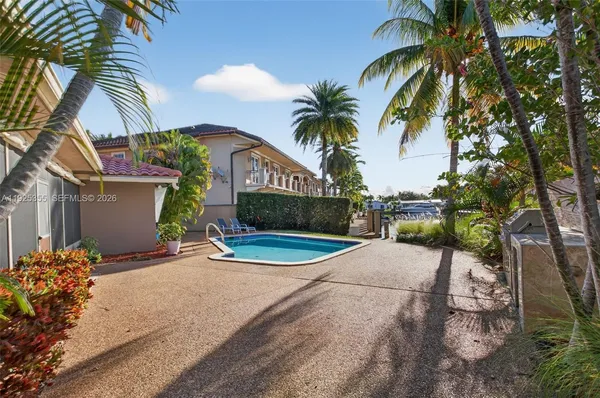 a view of a palm trees front of house