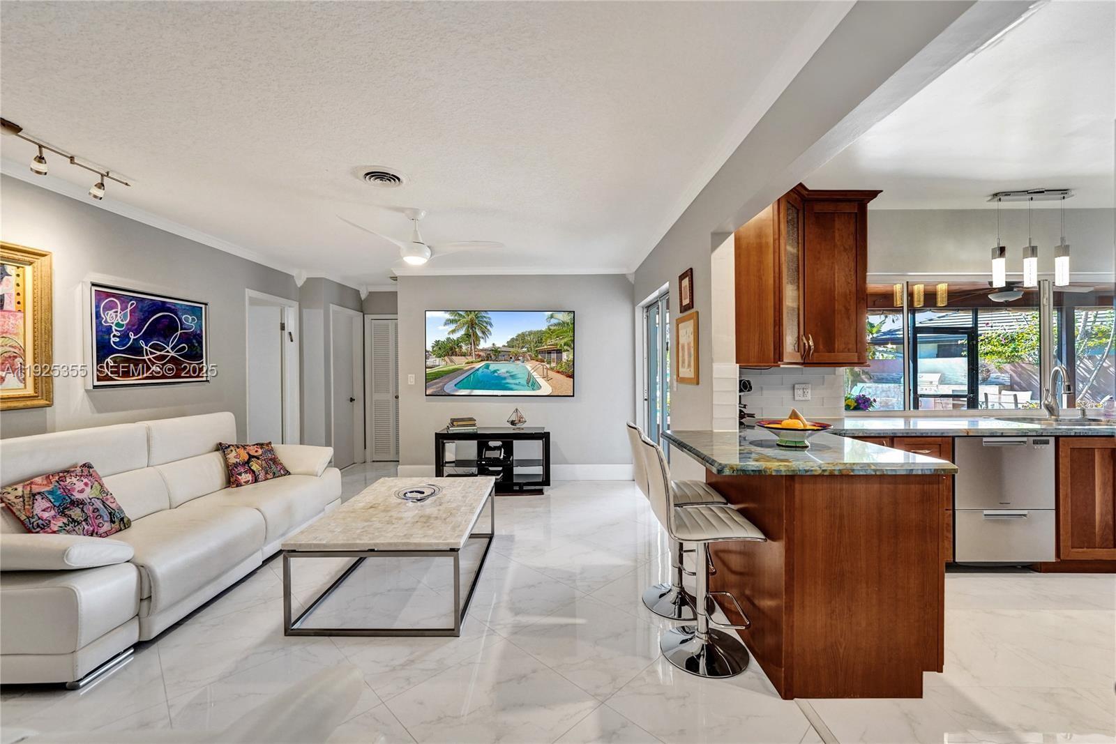 4060 Northeast 26th Avenue Lighthouse Point, FL 33064 - Photo 12 of 34 a living room with furniture and a flat screen tv