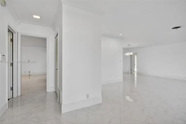a view of an empty room with window and cabinet