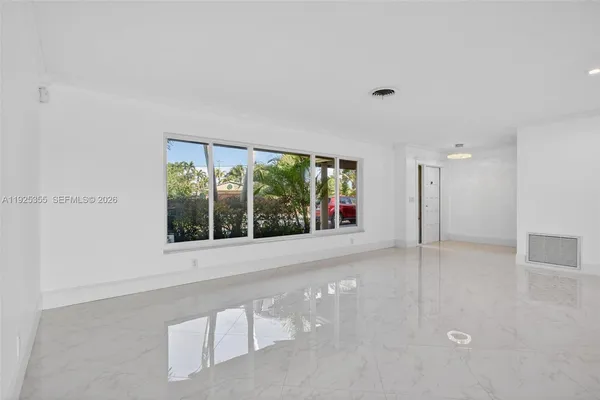 an empty room with windows and entrance