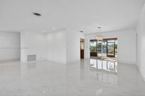 a view of a livingroom with furniture and floor to ceiling window