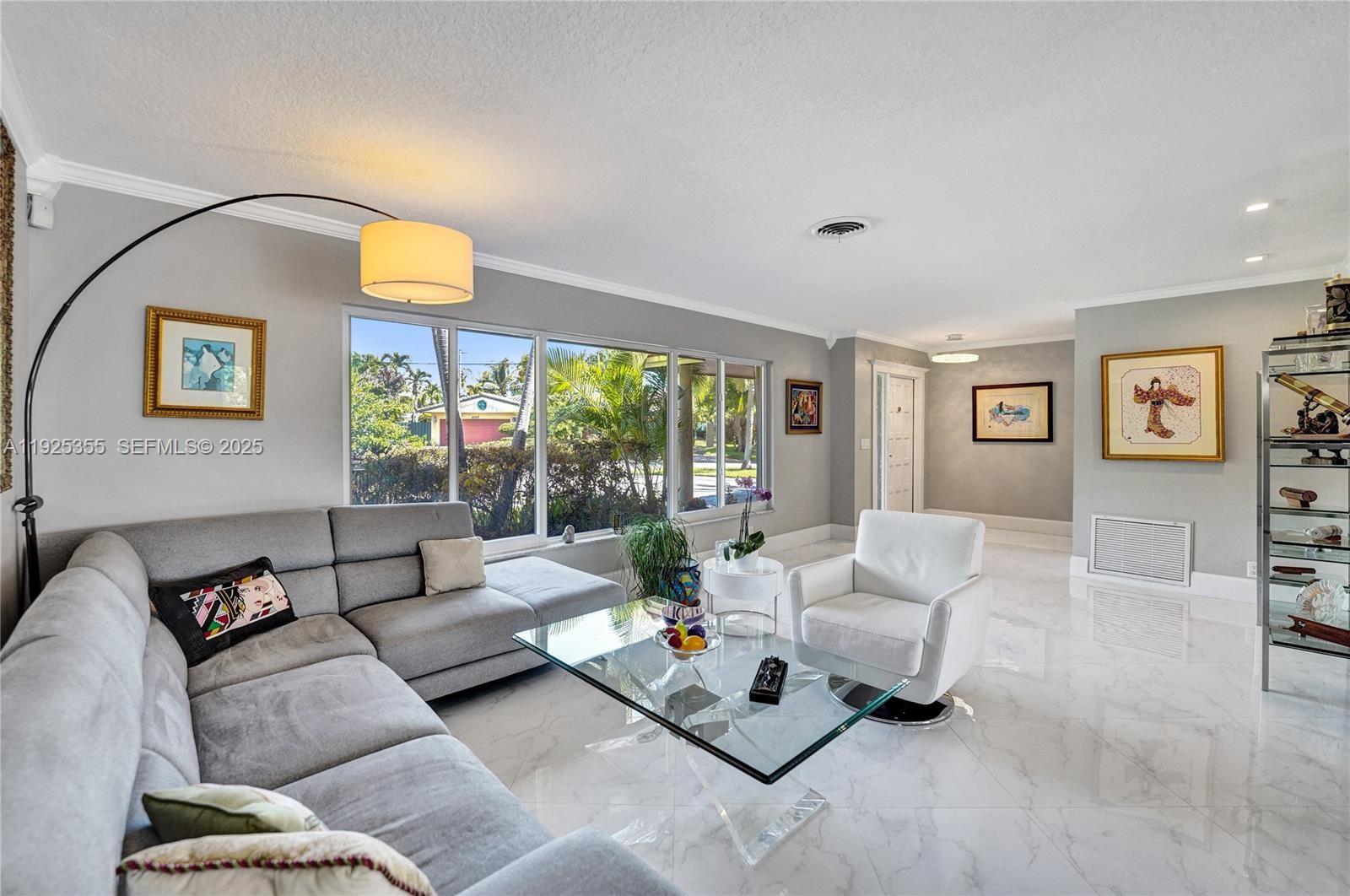 4060 Northeast 26th Avenue Lighthouse Point, FL 33064 - Photo 2 of 34 a living room with furniture and a large window