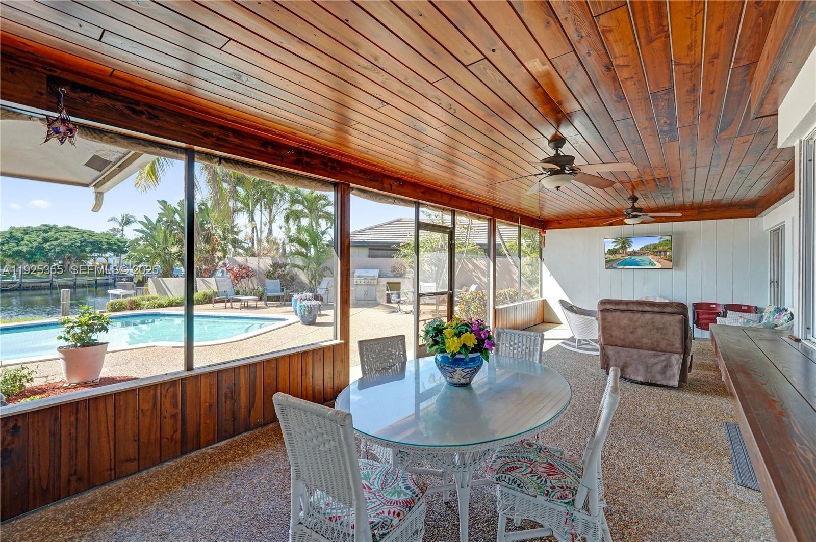 4060 Northeast 26th Avenue Lighthouse Point, FL 33064 - Photo 26 of 34 a dining room with furniture and a patio
