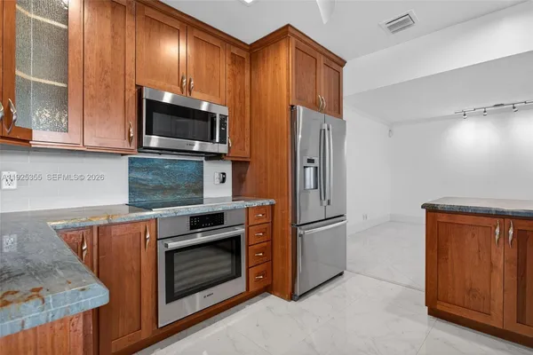 a kitchen with wooden cabinets and sink