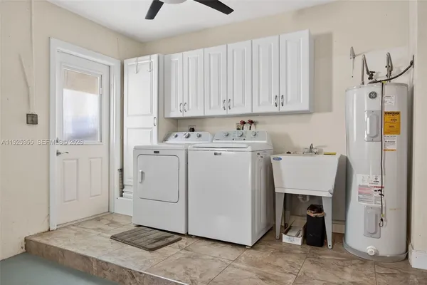 an empty room with cabinet and mirrors