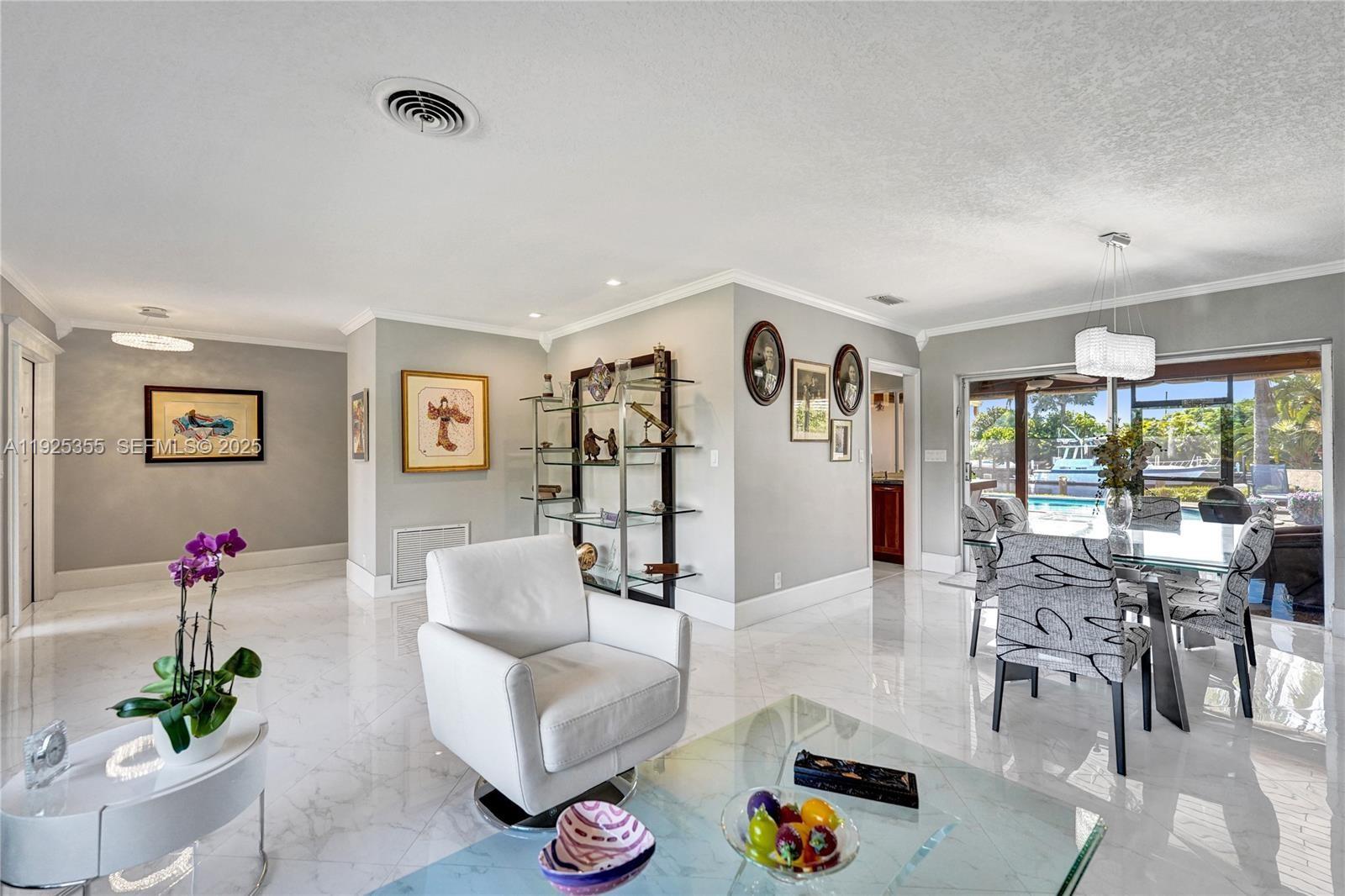 4060 Northeast 26th Avenue Lighthouse Point, FL 33064 - Photo 4 of 34 a living room with furniture and a large window
