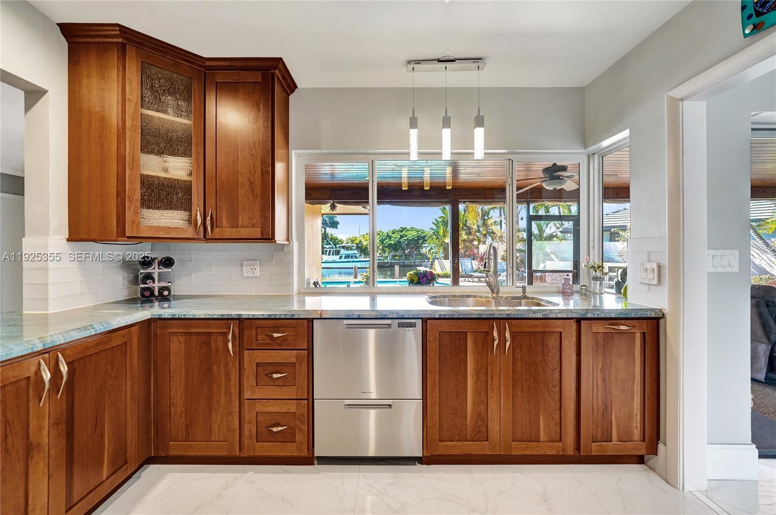 4060 Northeast 26th Avenue Lighthouse Point, FL 33064 - Photo 9 of 34 a kitchen with a sink window and cabinets
