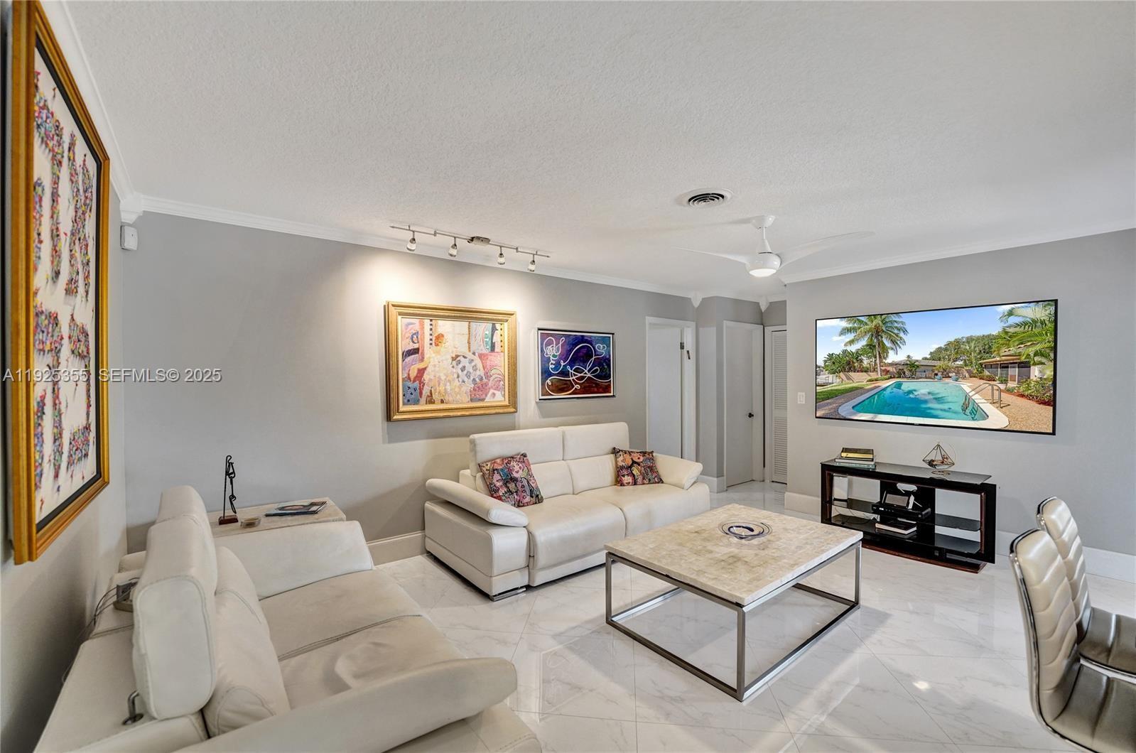 4060 Northeast 26th Avenue Lighthouse Point, FL 33064 - Photo 10 of 34 a living room with furniture and a flat screen tv