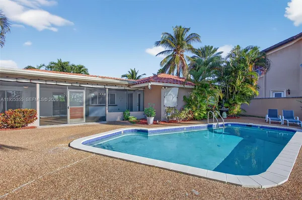 a view of a house with swimming pool and porch with furniture