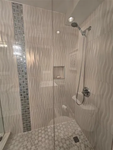 a room with painting on the wall and a wooden floor