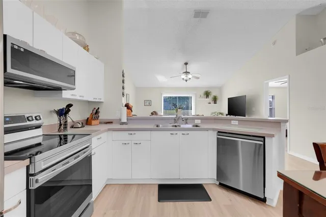 a kitchen with a sink stove and cabinets