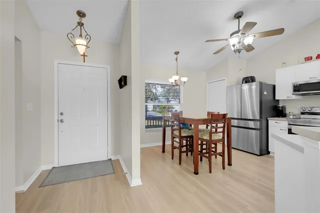 a view of a dining room with furniture and chandelier