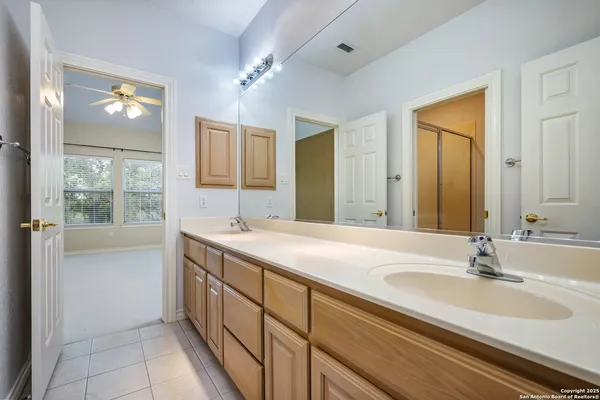 a bathroom with a sink double vanity granite and a mirror