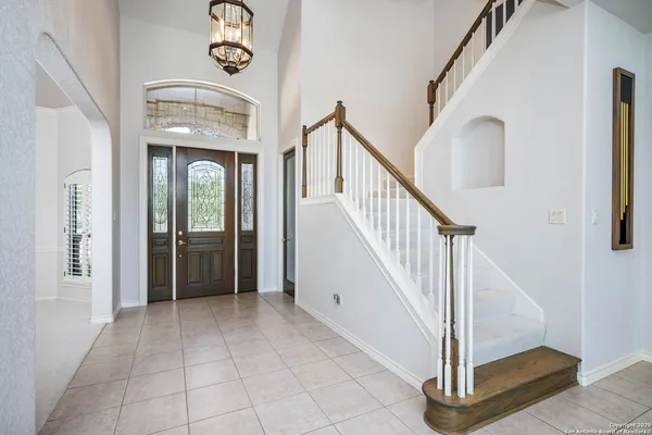 a view of a hallway with entryway and hall with wooden floor