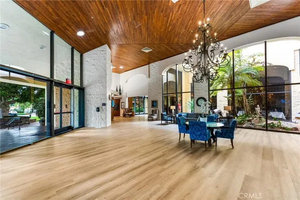 a view of a patio with table and chairs and floor to ceiling window