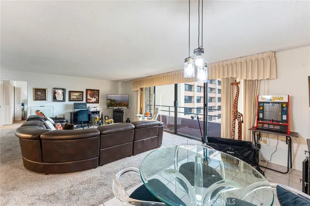 a living room with fireplace furniture and a chandelier