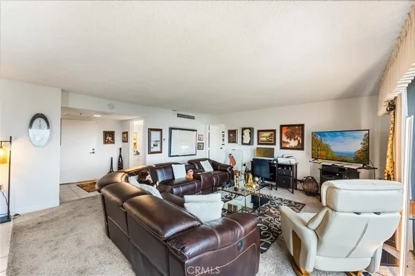 a living room with furniture a large window and a flat screen tv