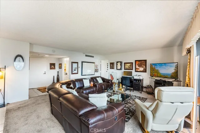 a living room with furniture a large window and a flat screen tv