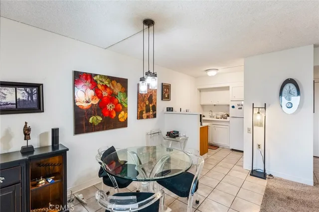 a living room with furniture a flat screen tv and a wall clock