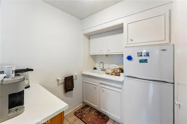 a kitchen with a refrigerator and cabinets