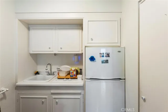 a white refrigerator freezer sitting inside of a kitchen