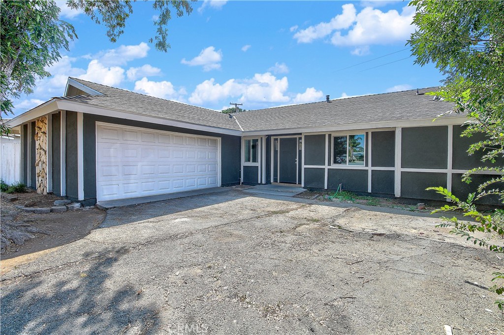 11250 Kern Place Riverside, CA 92505 - Photo 1 of 1 a front view of a house with a yard and garage