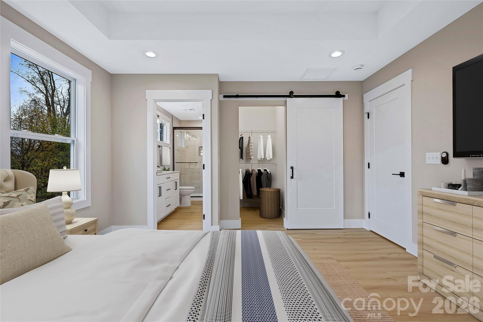 424 Hazel Mill Road Asheville, NC 28806 - Photo 34 of 47 a bedroom with a bed and a flat tv screen