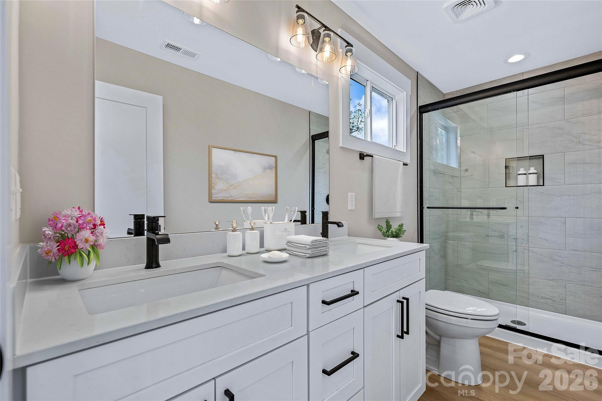 424 Hazel Mill Road Asheville, NC 28806 - Photo 35 of 47 a bathroom with a granite countertop sink mirror vanity and toilet