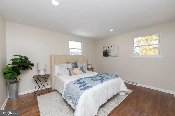 a bedroom with a bed and a potted plant