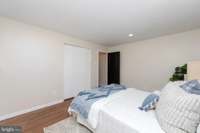 a bedroom with a bed and a night stand