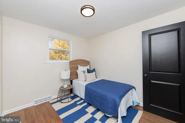 a bedroom with a bed and a table in it