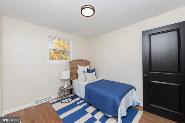 a bedroom with a bed and a table in it