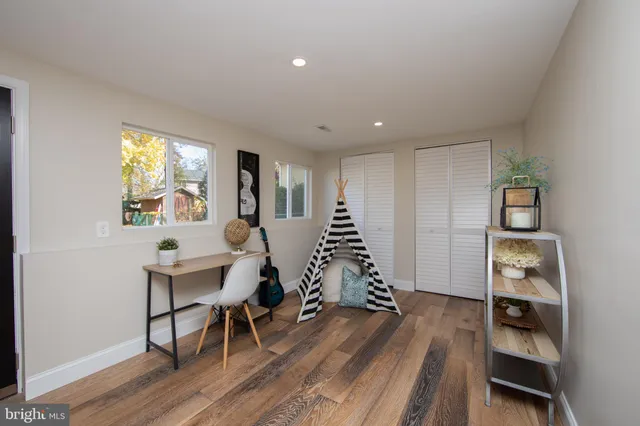 a living room with furniture a wooden floor and a window