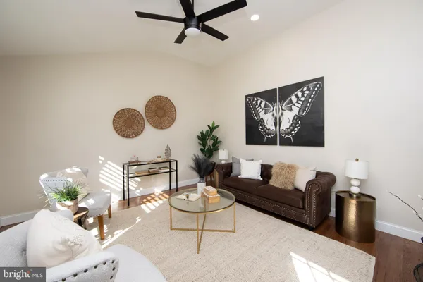 a living room with furniture and a wall painting