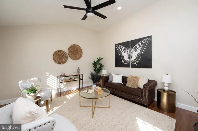 a living room with furniture and a wall painting