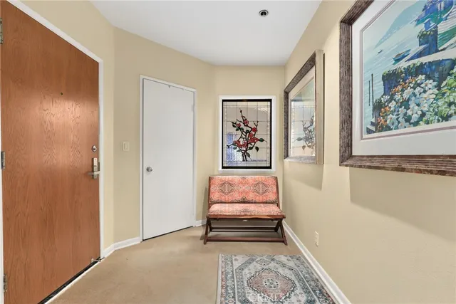 a living room with furniture and large windows