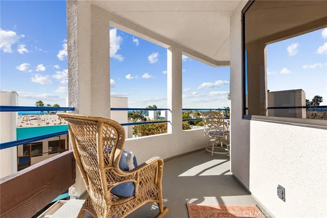 a view of a chairs and table in the balcony