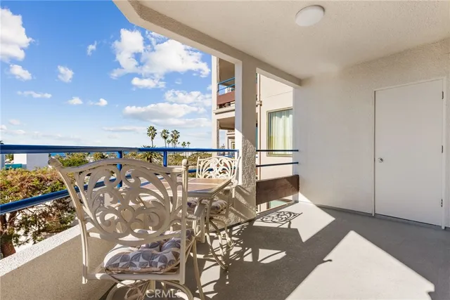 a view of a balcony with chairs and a table