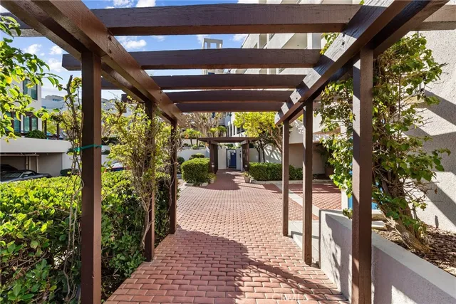 a view of a hallway with wooden floor and living room
