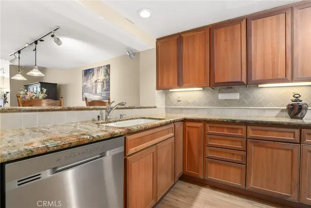 a kitchen with stainless steel appliances granite countertop a stove microwave and refrigerator