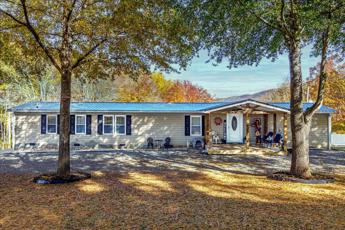 448 Lakeside Road Penhook, VA 24137 - Photo 2 of 51 a front view of a house with large trees and a big yard