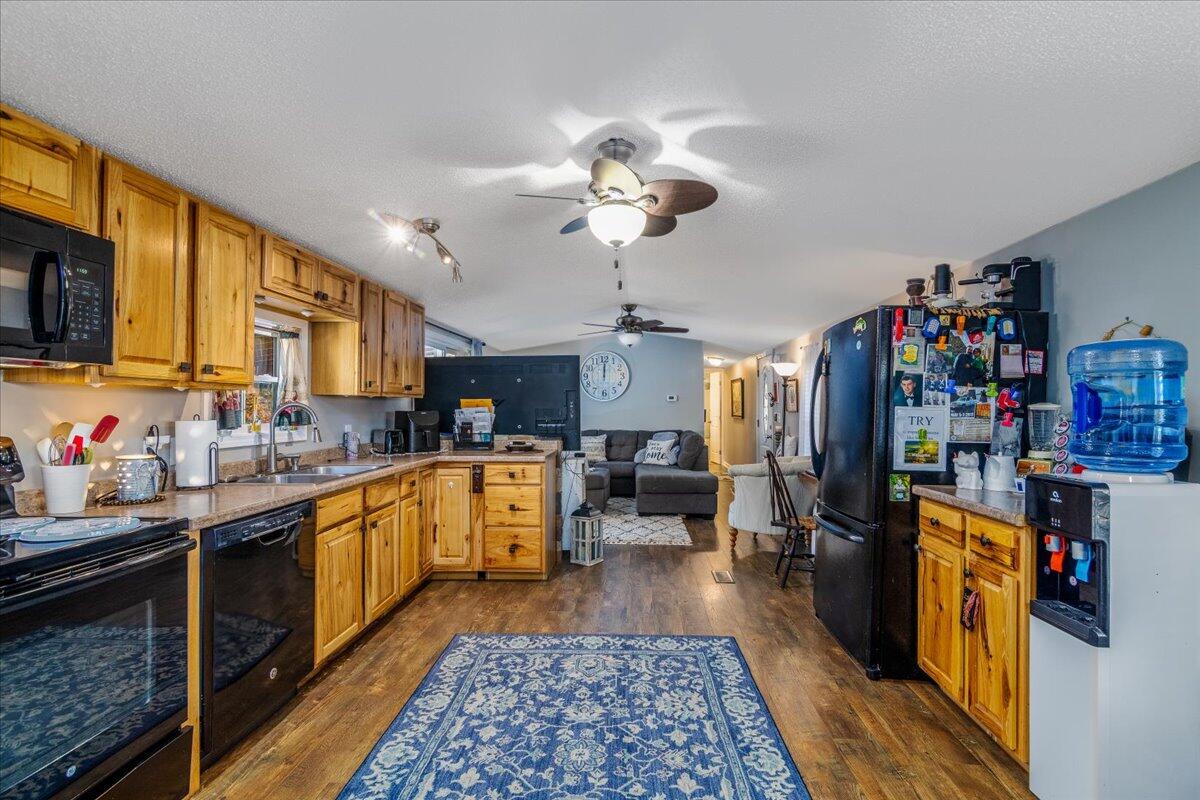 448 Lakeside Road Penhook, VA 24137 - Photo 20 of 51 a kitchen with stainless steel appliances granite countertop a refrigerator a sink dishwasher a stove and a dining table with wooden floor