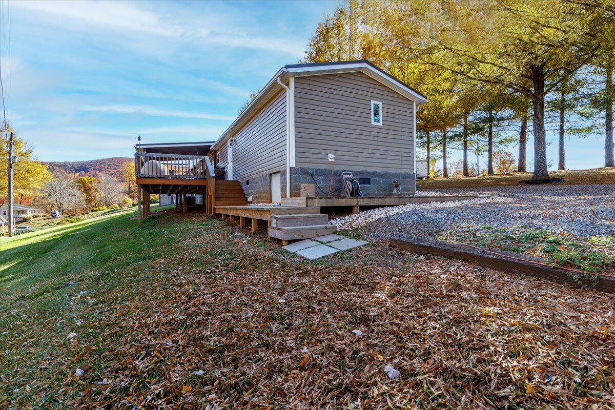 448 Lakeside Road Penhook, VA 24137 - Photo 34 of 51 a backyard of a house with barbeque oven fire pit table and chairs
