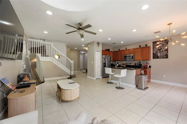 a kitchen with a sink and a stove top oven with wooden floor