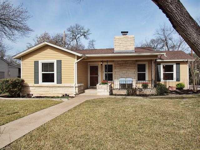 a front view of a house with yard and porch