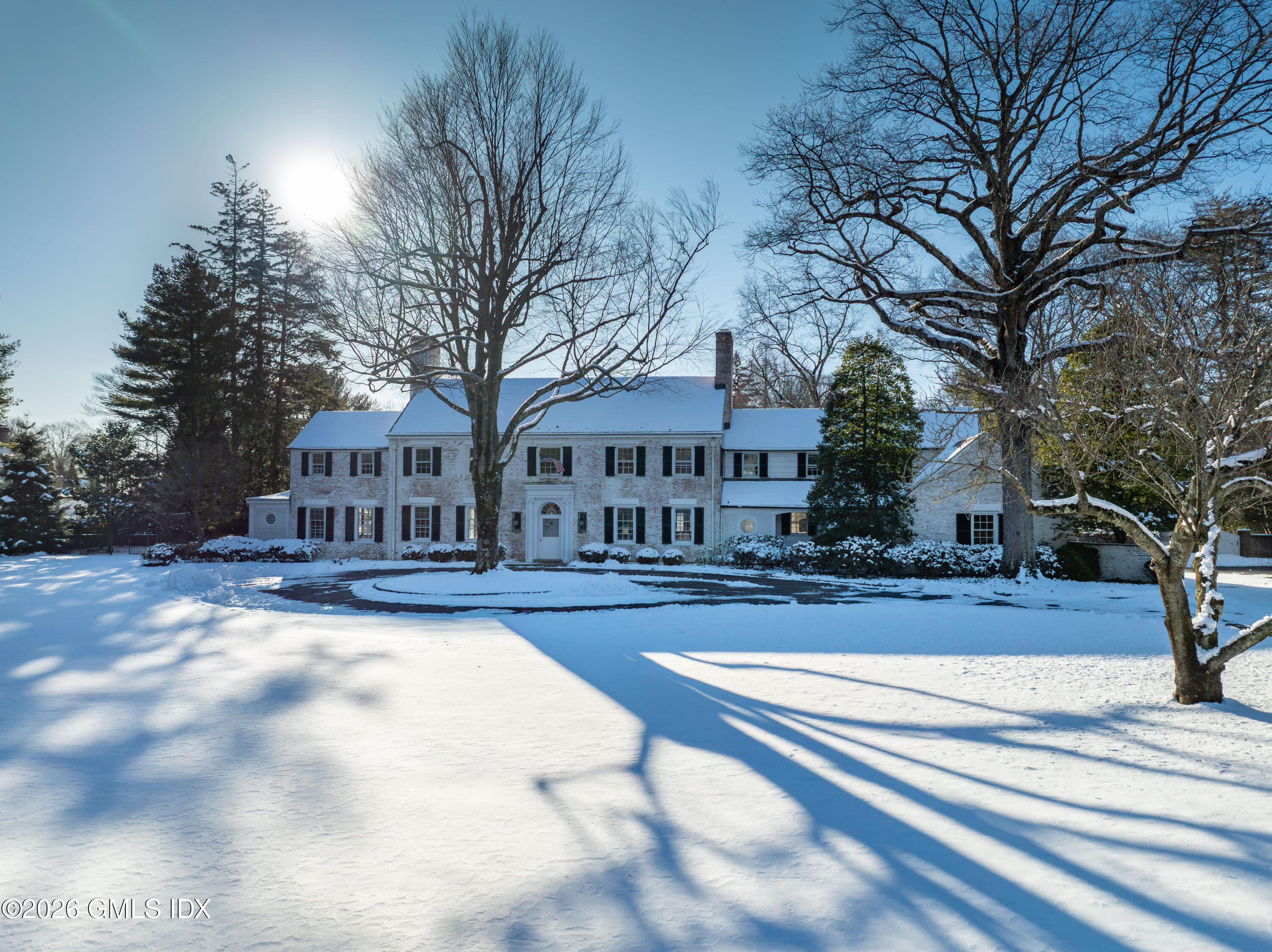 12 Woodside Road Greenwich, CT 06830 - Photo 2 of 11 a view of a house with a yard and large trees