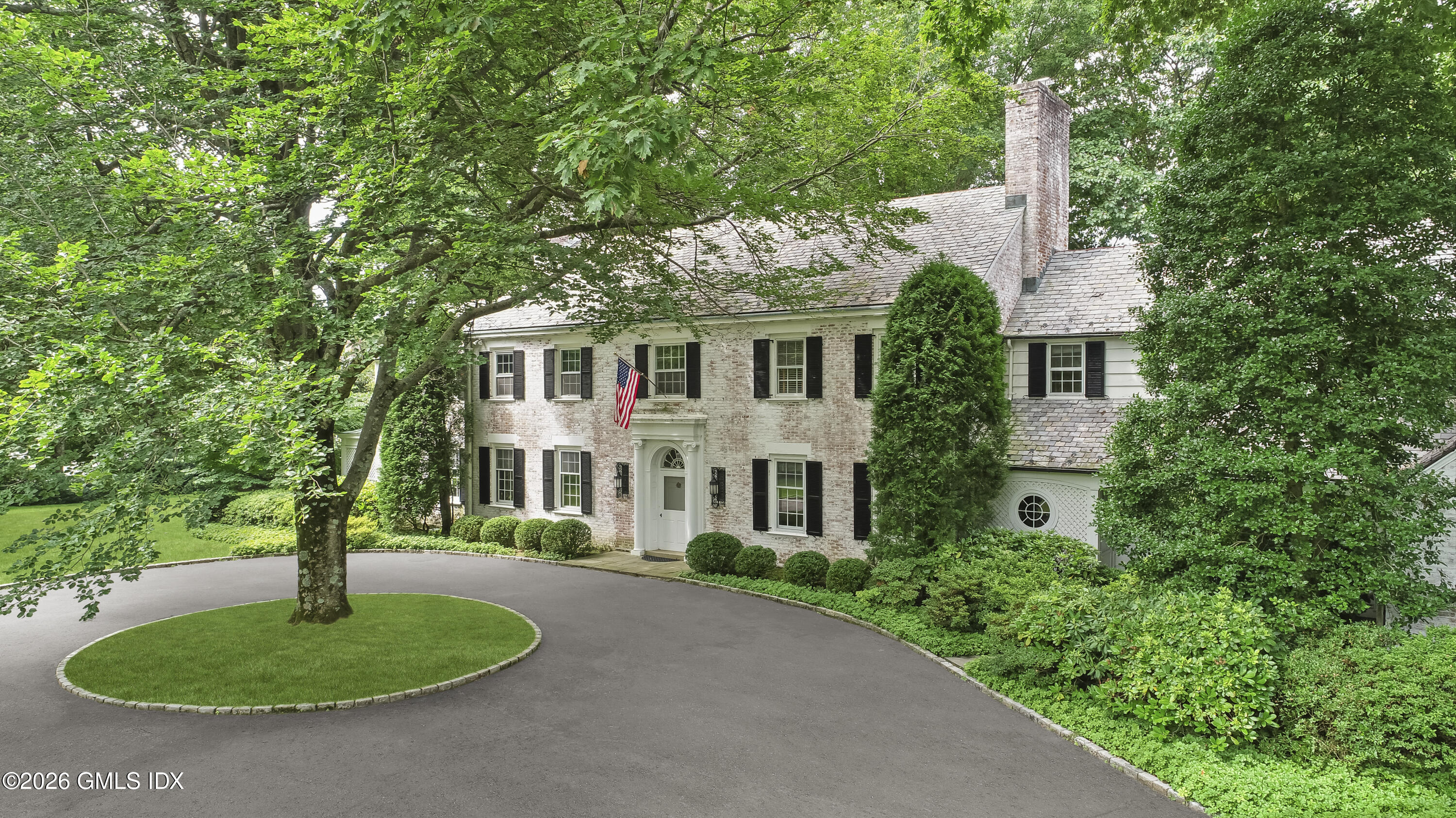 12 Woodside Road Greenwich, CT 06830 - Photo 2 of 7 a front view of a house with a garden