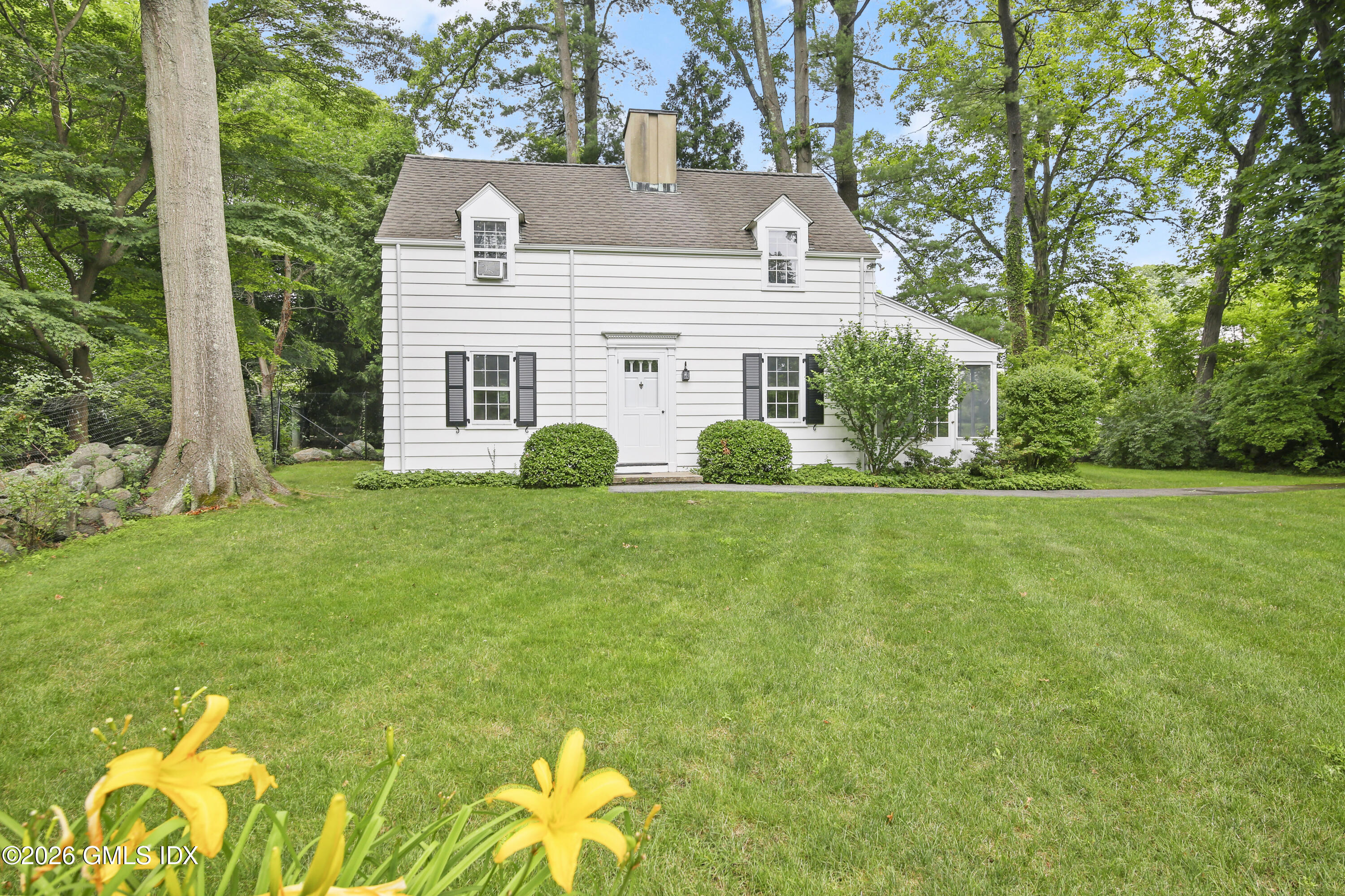 12 Woodside Road Greenwich, CT 06830 - Photo 4 of 7 a view of a house with a backyard