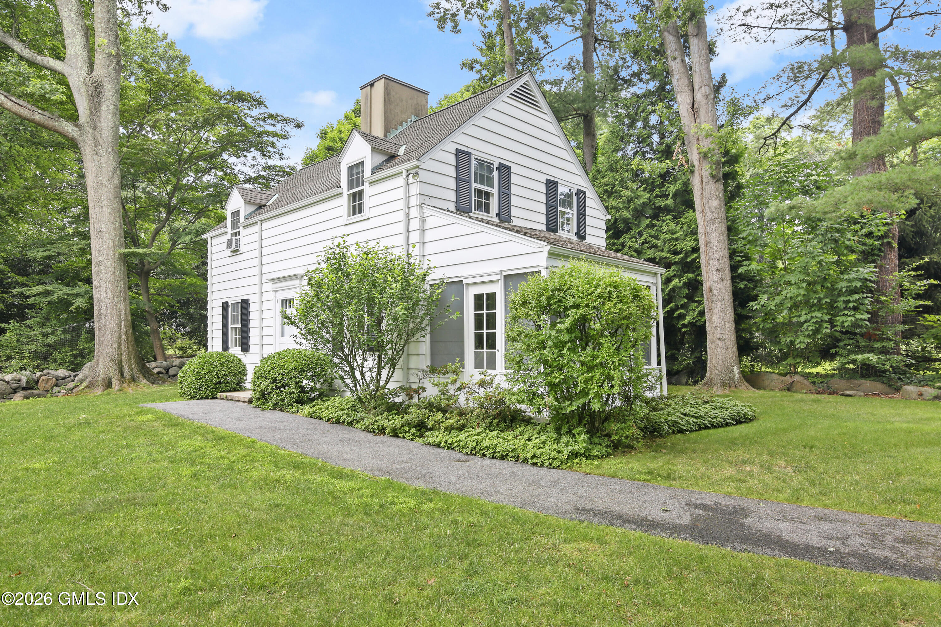 12 Woodside Road Greenwich, CT 06830 - Photo 5 of 7 a front view of a house with a yard